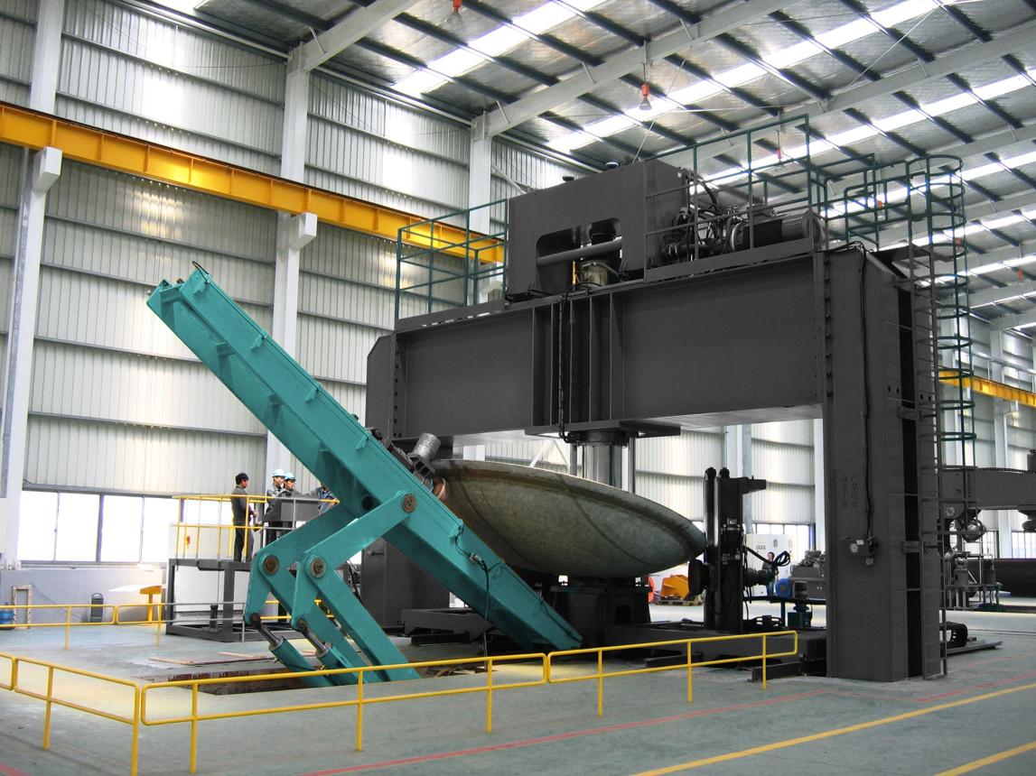 Forming a large-diameter dish end on an industrial press.